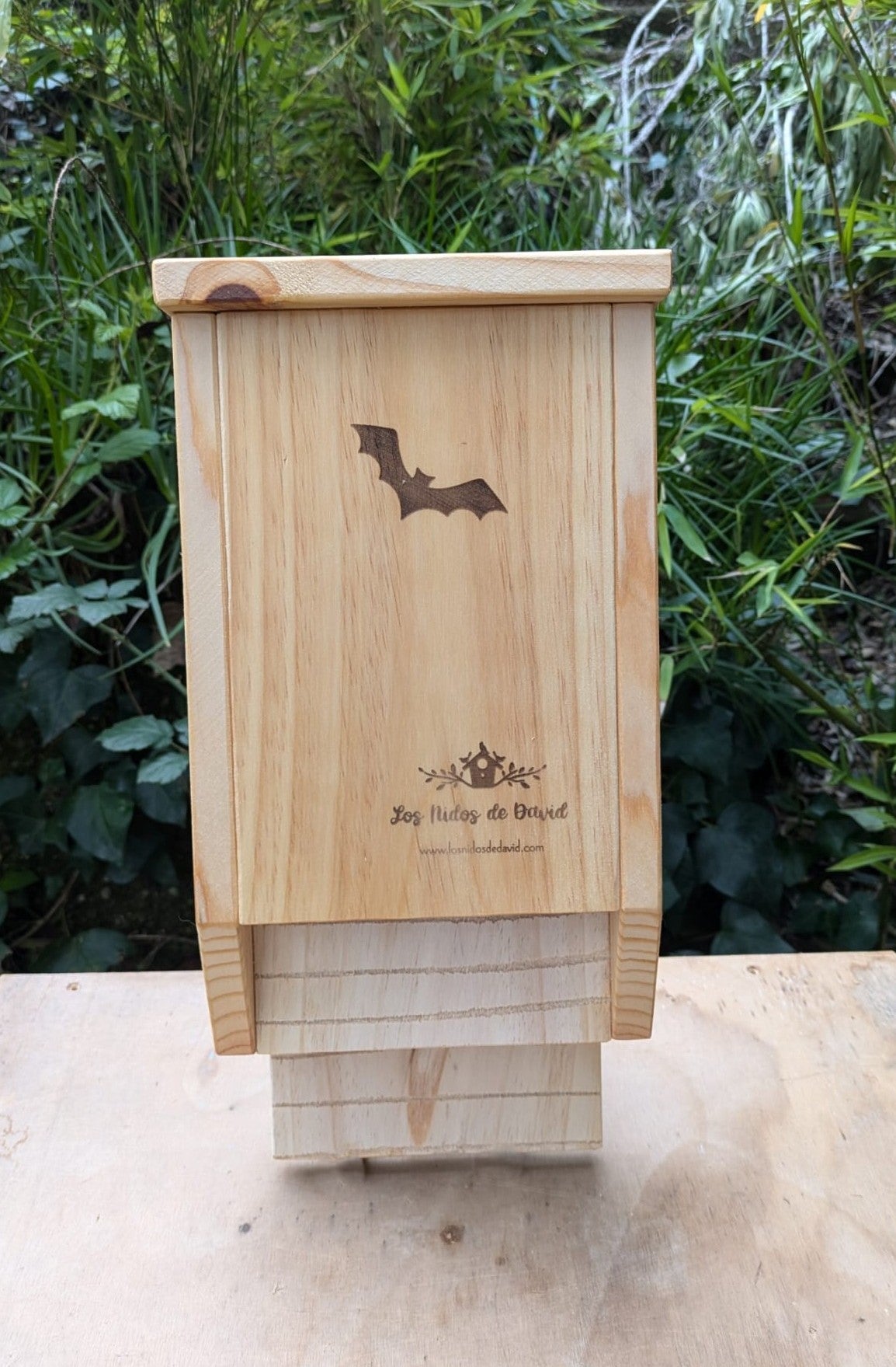 Caja refugio para murciélagos de doble cámara fabricada en madera de pino, vista frontal con acceso inferior.